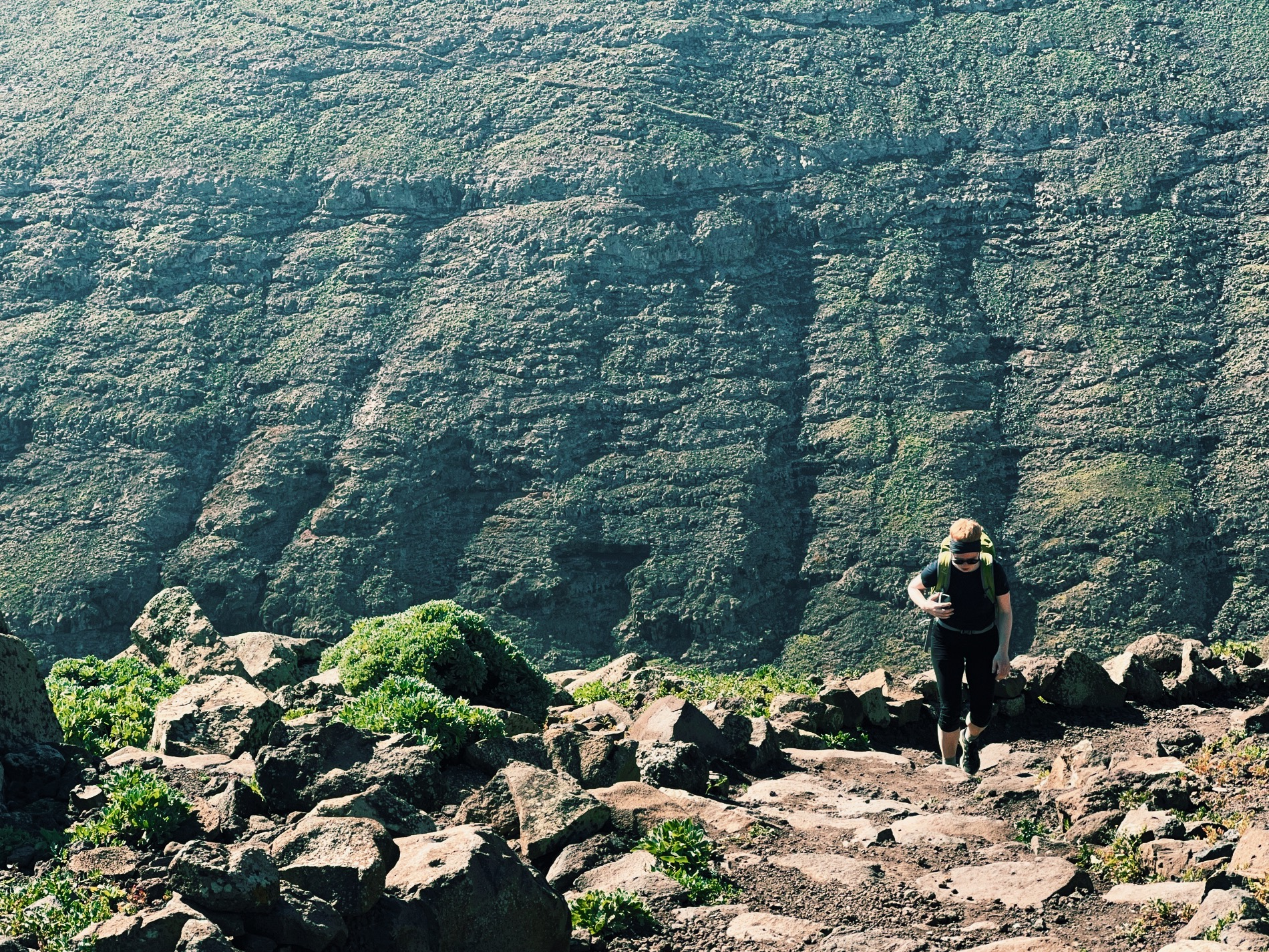 Women hiking in front of green volcano mountains at Pico de La Zarza, Fuerteventura