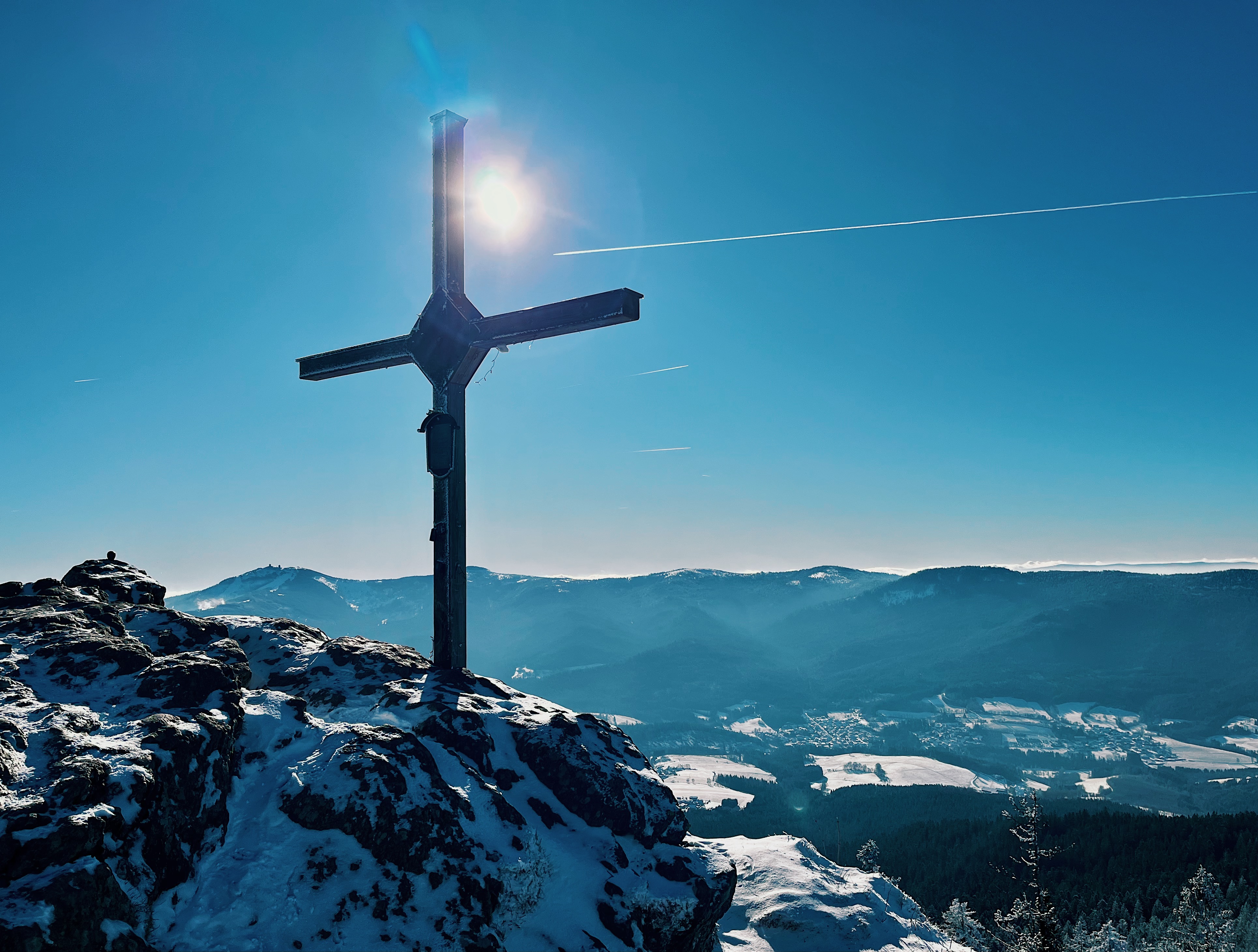 Cross on the summit of mount Osser in Bavaria in winter