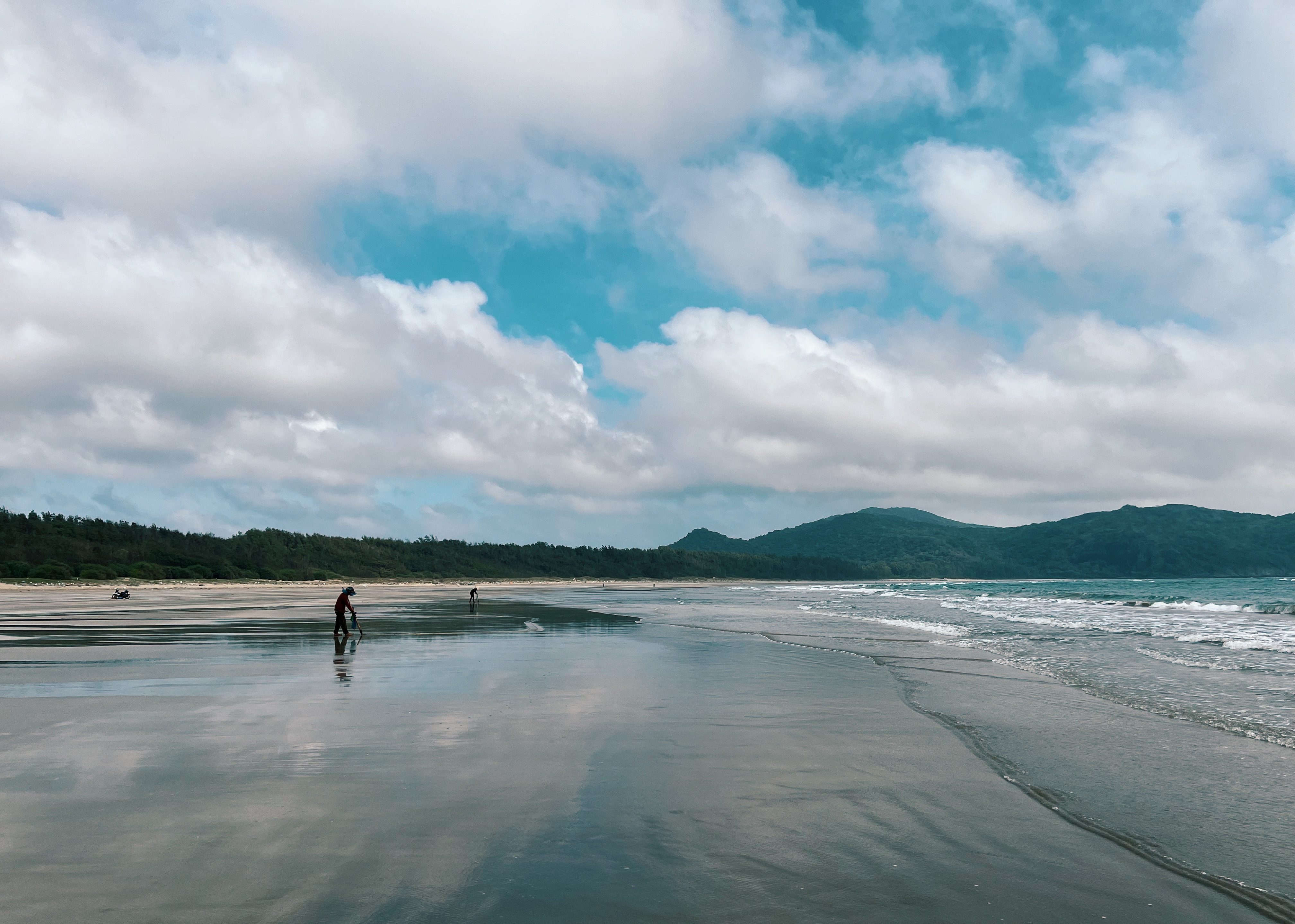 People collecting shellfish on a beautiful beach on Con Dao Island, Vietnam